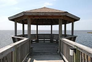 a wooden pier with a gazebo on the water at 2437 - Sandpiper Station in Duck