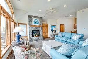 a living room with blue furniture and a fireplace at 2440 - Solitude South in Duck +40 photos