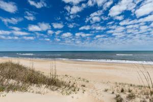 an empty beach with the ocean in the background at 2440 - Solitude South in Duck