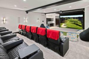a cinema room with chairs and a golf simulator at Grand Retreat in Cle Elum +80 photos
