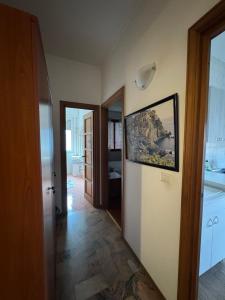 a room with a hallway with a painting on the wall at appartamento la conchiglia in Rapallo