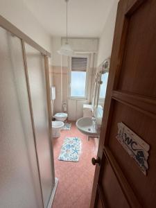 an open door to a bathroom with a toilet at appartamento la conchiglia in Rapallo +5 photos