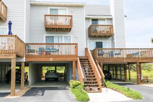 a apartment building with wooden stairs and balconies at 4204 - Outer Thanks in Duck