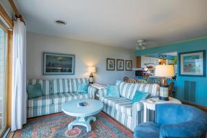 a living room with two couches and a table at 4204 - Outer Thanks in Duck