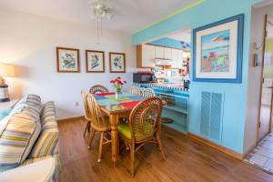 a kitchen and dining room with a table and chairs at 4204 - Outer Thanks in Duck +37 photos