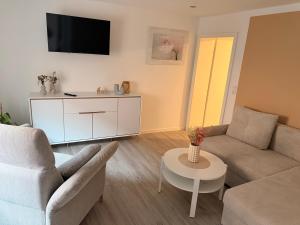 a living room with a couch and a table at Ferienwohnung Cookie in Elxleben