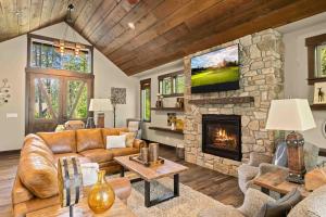 a living room with a couch and a stone fireplace at Parkside Lodge in Cle Elum
