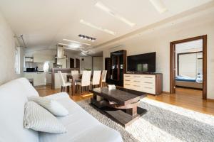 a living room with a white couch and a table at Lux Apartment "Lea" in Kotor