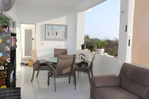 a dining room with a table and chairs at Valentina Salchi Bay virgin beaches fast internet in Cuatunalco