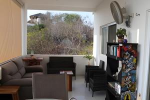 a living room with a couch and a window at Valentina Salchi Bay virgin beaches fast internet in Cuatunalco