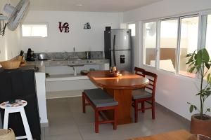 a kitchen with a wooden table and a counter top at Valentina Salchi Bay virgin beaches fast internet in Cuatunalco +45 photos
