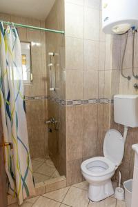 a bathroom with a shower with a toilet and a sink at Villa Elezi in Ulcinj +117 photos
