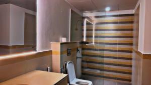 a bathroom with a toilet and a sink at One Constitution Avenue by Goldfinch, Luxury apartments near Diplomatic Enclave and Serena in Islamabad +83 photos