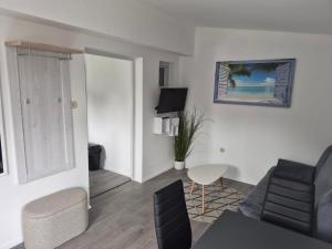 a living room with a couch and a table at Solmar Adriatica Apartman in Banjole