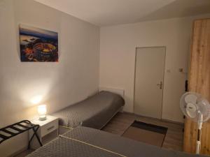 a small bedroom with a bed and a door at Solmar Adriatica Apartman in Banjole