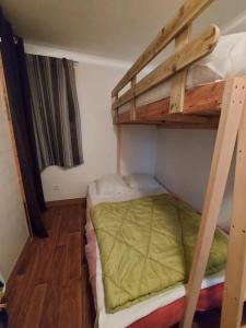 a small room with two bunk beds in it at ZEcamping 3 étoiles avec piscine et pataugeoire in Saint-Projet