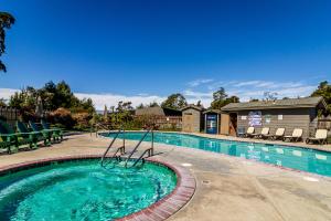 a swimming pool at a resort with chairs at J Patrick Inn in Cambria