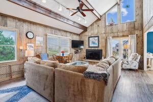 a living room with a couch and a tv at 3979 - Wright by the Coast in Duck