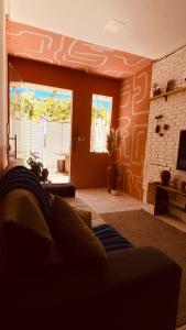 a living room with a couch and a fireplace at Bossa Nova Home in Barra dos Coqueiros