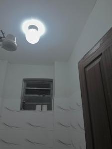 a bathroom with a light and a window on the ceiling at Blissful Homes in Thika