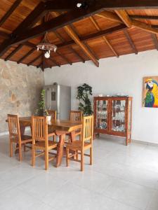 a dining room with a wooden table and chairs at Pedacinho do céu in Tiradentes