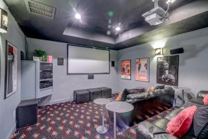a living room with a couch and a screen at 2869 - Seascape in Duck