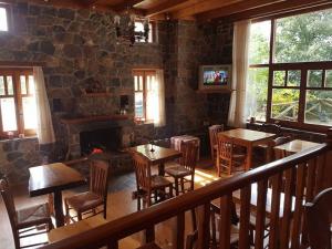 un restaurante con mesas y sillas y una pared de piedra en Hotel Semeli, en Goura