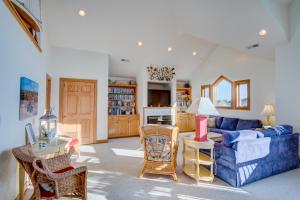 a living room with a blue couch and chairs at 4052 - Mirth N Mist II in Duck