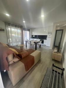 a large bedroom with a large bed and a kitchen at Meirinha House in Viana do Castelo