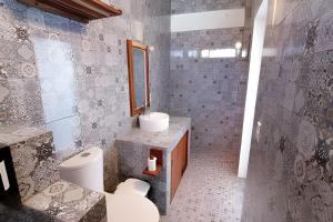 a bathroom with a toilet and a sink at Valentina Salchi suites virgin beaches internet in Cuatunalco +18 photos