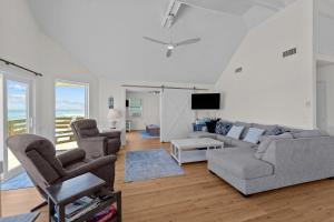 a living room with a couch and two chairs at 7675 - Sweet Caroline in Avon
