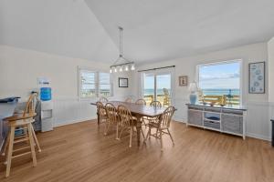a dining room and kitchen with a table and chairs at 7675 - Sweet Caroline in Avon +51 photos