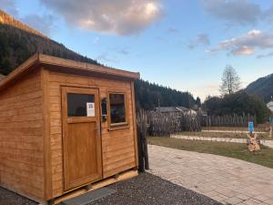 a small wooden building with a window in a field at Sleep-box Radwerk 14 in Vordernberg