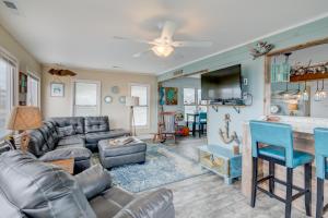a living room with a couch and a table at 7022 - East Point El Dorado in Rodanthe