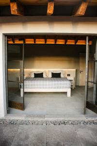 a bedroom with a bed in the middle of a room at Casa Chichipicas Hotel Boutique in Valle de Bravo