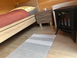 a bedroom with a bed and a fire place at Sleep-box Radwerk 14 in Vordernberg