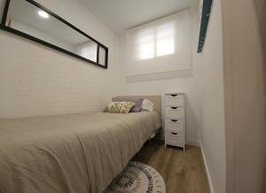a bedroom with two beds and a dresser and a window at Residencial Colibrí in Cambrils +39 photos