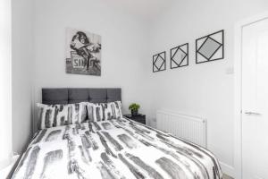 a bedroom with a bed with a black and white comforter at Romantic getaway with private hot tub in Belfast