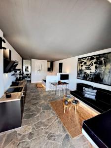 a living room with a couch and a table at Mykonos Dot Art Homes in Ano Mera