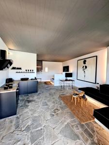 a living room with a couch and a table at Mykonos Dot Art Homes in Ano Mera