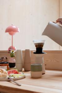 a table with a blender and a plate of food at biYou Ecoquartier in den Bergen in Schladming