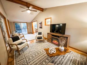a living room with a fireplace and a flat screen tv at Blue Ribbon Cabin in Farwell