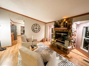 a living room with a fireplace and a couch at Blue Ribbon Cabin in Farwell