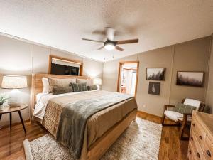 a bedroom with a bed and a ceiling fan at Blue Ribbon Cabin in Farwell