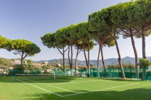 a tennis court with palm trees on it at Casa Concetta in Rapallo