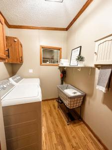 a small kitchen with a sink and a basket in it at Blue Ribbon Cabin in Farwell +22 photos