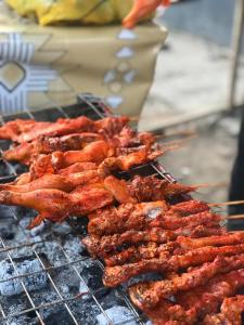a bunch of food cooking on a grill at Classic Hotel by TWM in Ibadan