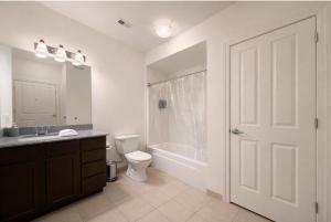 a bathroom with a toilet and a sink and a shower at Designer UAB Condo King Bed Balcony View 2 in Birmingham
