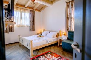 a bedroom with a white bed and a blue chair at River Bridge in Žabljak
