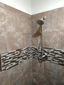 a shower with a shower head in a bathroom at Unit 17 Large 1 Bed 1 Bath Condo Ocean Views in Pahala +15 photos